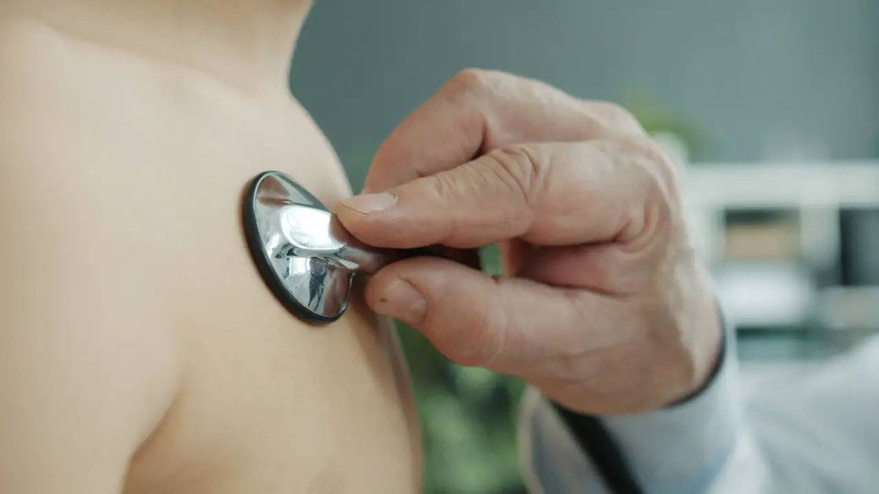 Doctor Listening to Patient's Heart with Stethoscope